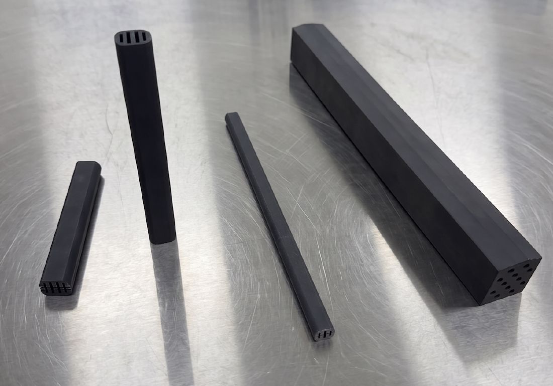 Four SMC impeder cores of different diameters on a stainless steel table